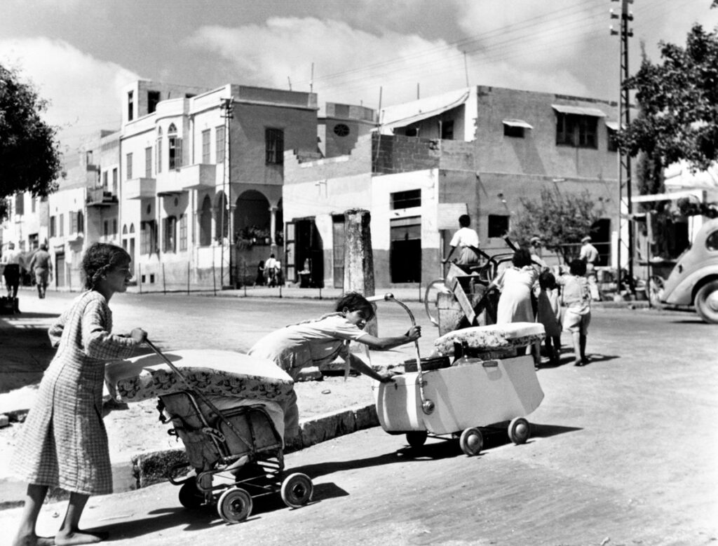 فتيات فلسطينيات يحملن أمتعتهن أثناء مغادرة مدينة يافا في نكبة فلسطين عام 1948.